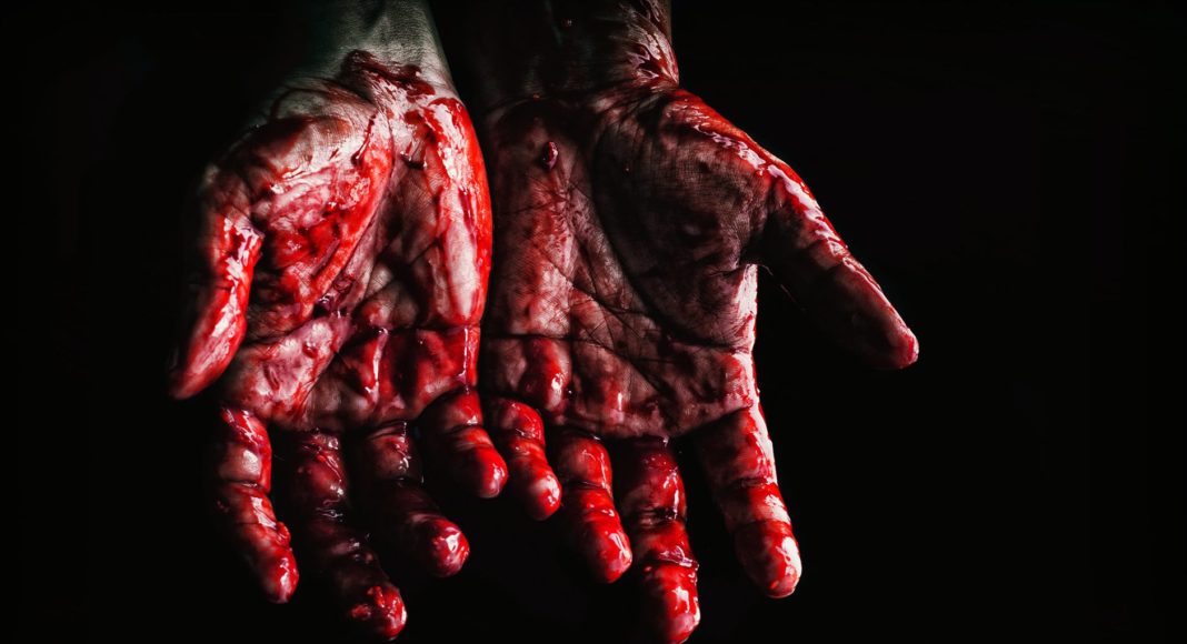 person s hands covered with blood