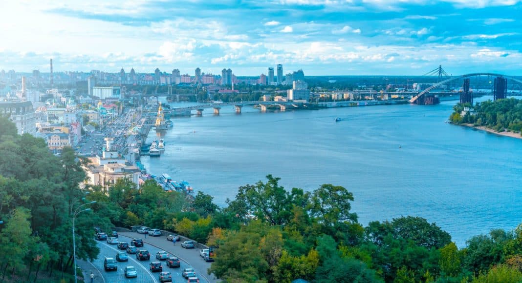 vehicles on road beside sea