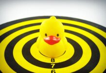 yellow rubber duckie on dart board