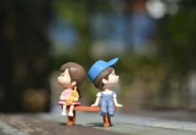 boy and girl sitting on bench toy