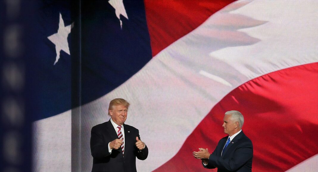 Donald Trump beside man in black suit