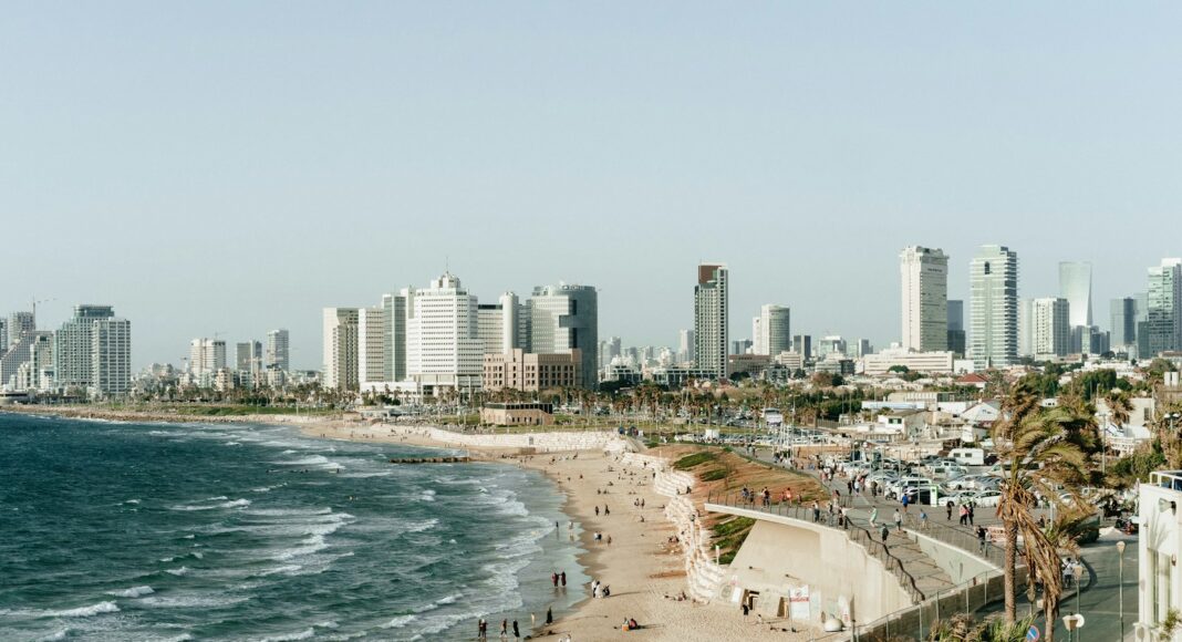 people on seashore under gray sky during daytime