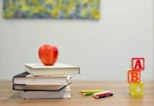 red apple fruit on four pyle books