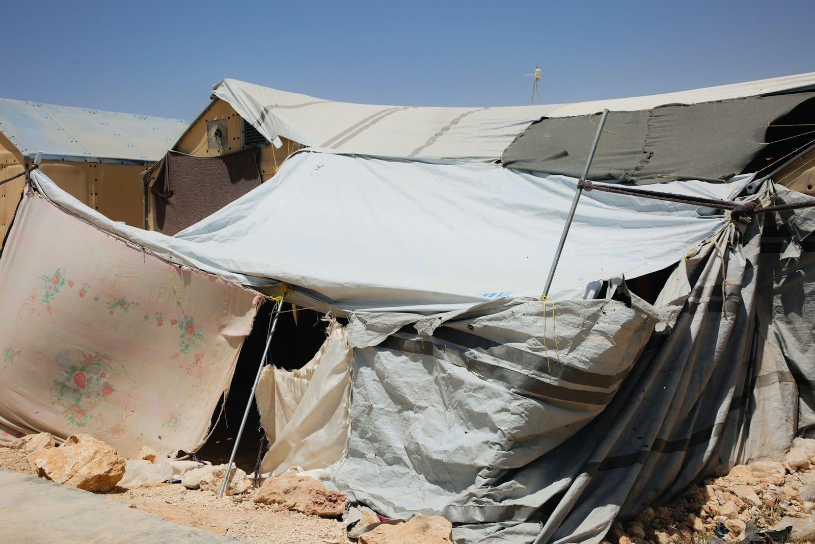 A group of tents sitting on top of a dirt field