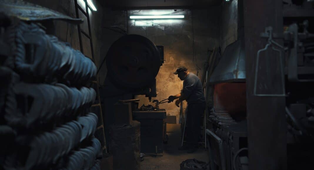 A man is working in a dark room