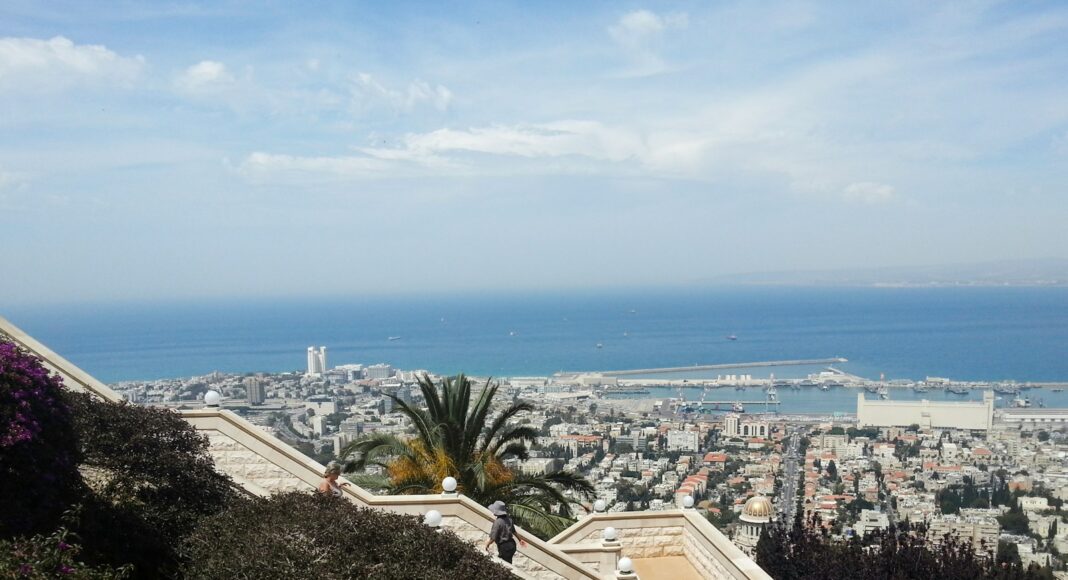 aerial view of city buildings near body of water during daytime
