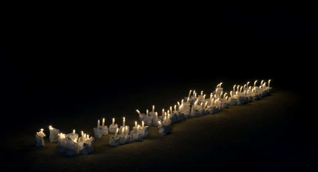 A group of white candles sitting on top of a table