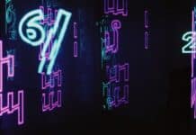 neon signs are lit up in a dark room