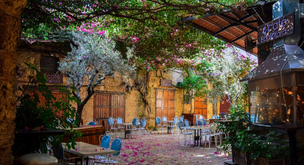 a courtyard with tables and chairs