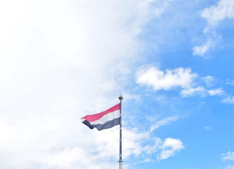 a flag flying in front of a sign that says atlanta