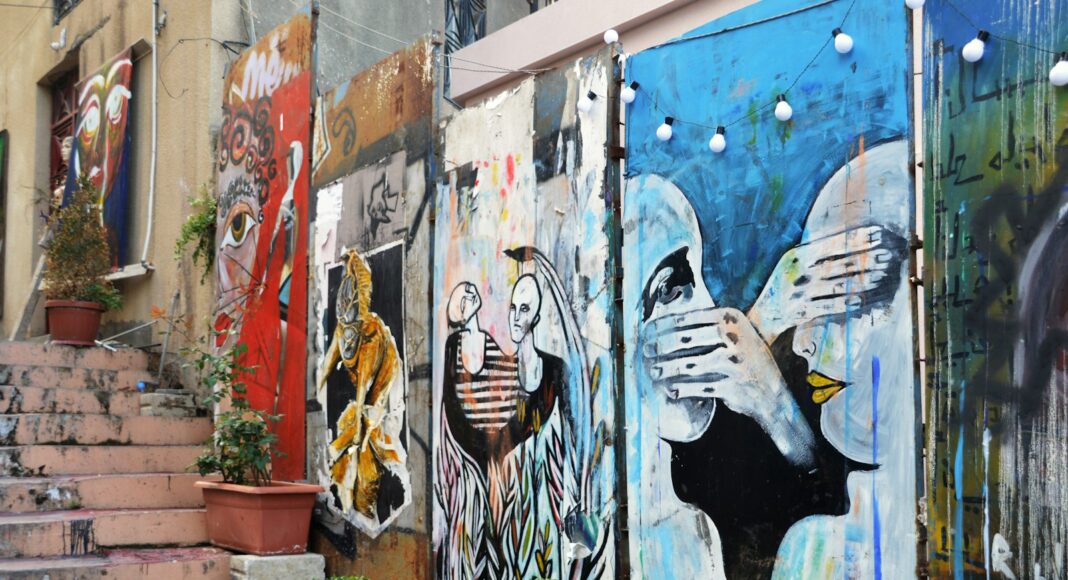 woman in black and white stripe shirt and blue denim jeans graffiti