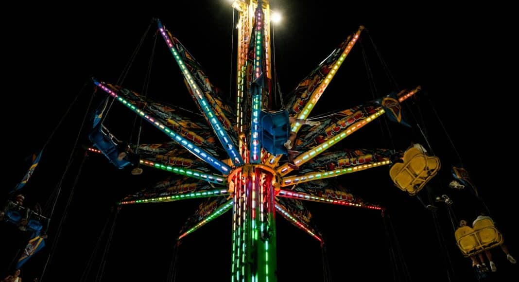 A merry go round ride lit up at night