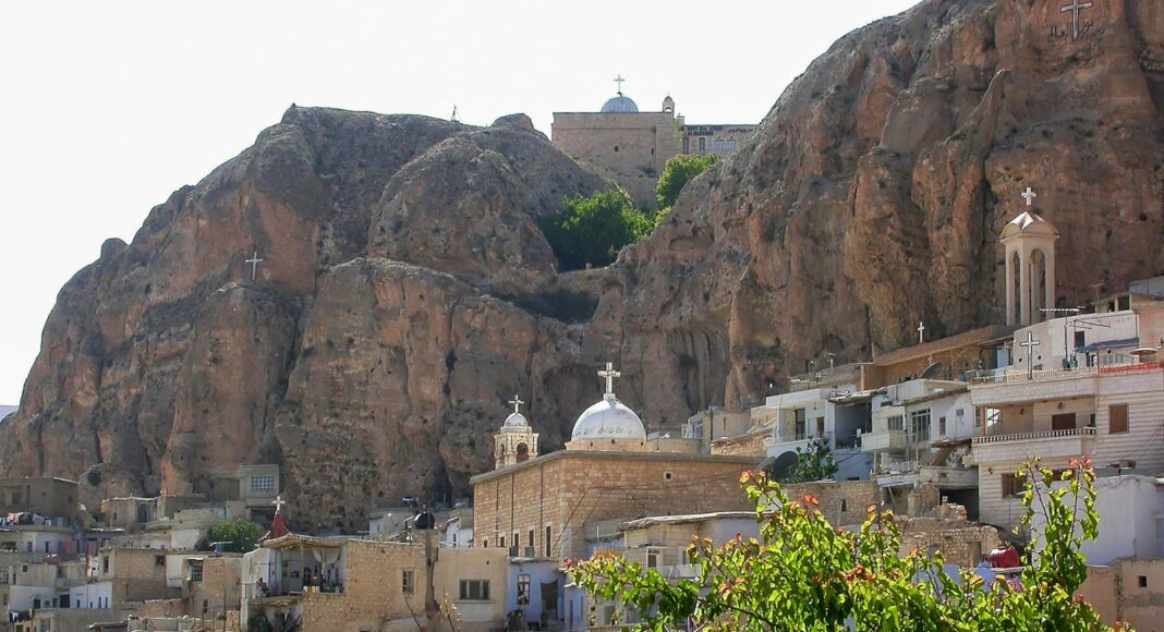 A view of a city with a mountain in the background
