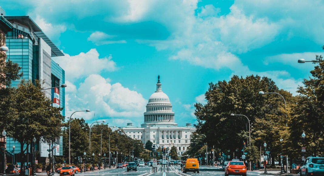 wide road with vehicle traveling with white dome building