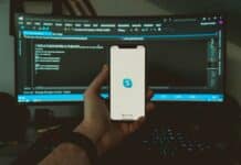 person holding white iphone 5 c