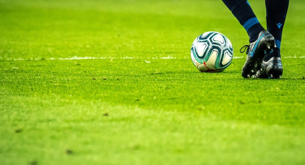 man playing soccer game on field