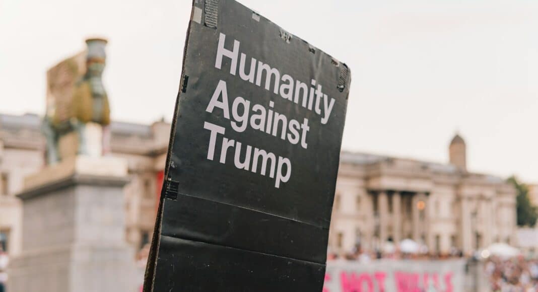 humanity against trump signage near buildings