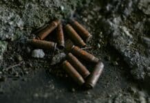 brown cigarette butts on black surface
