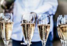 four clear champagne flutes